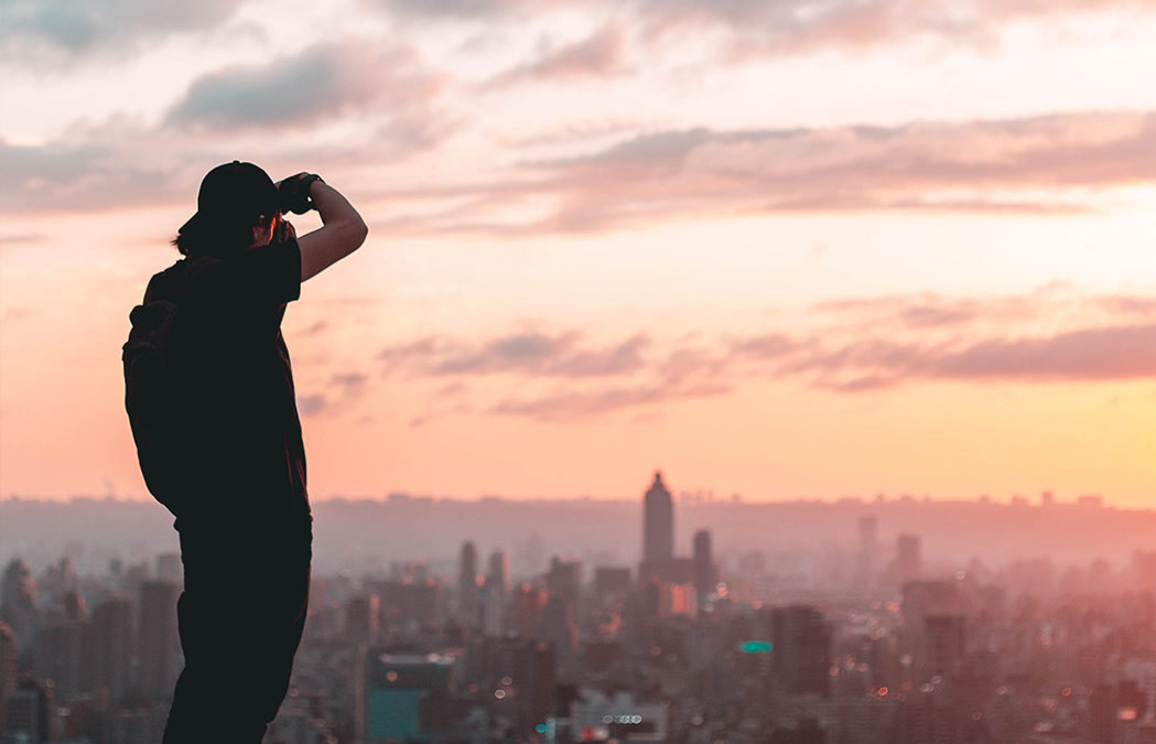 Image of man taking a photo on a rooftop