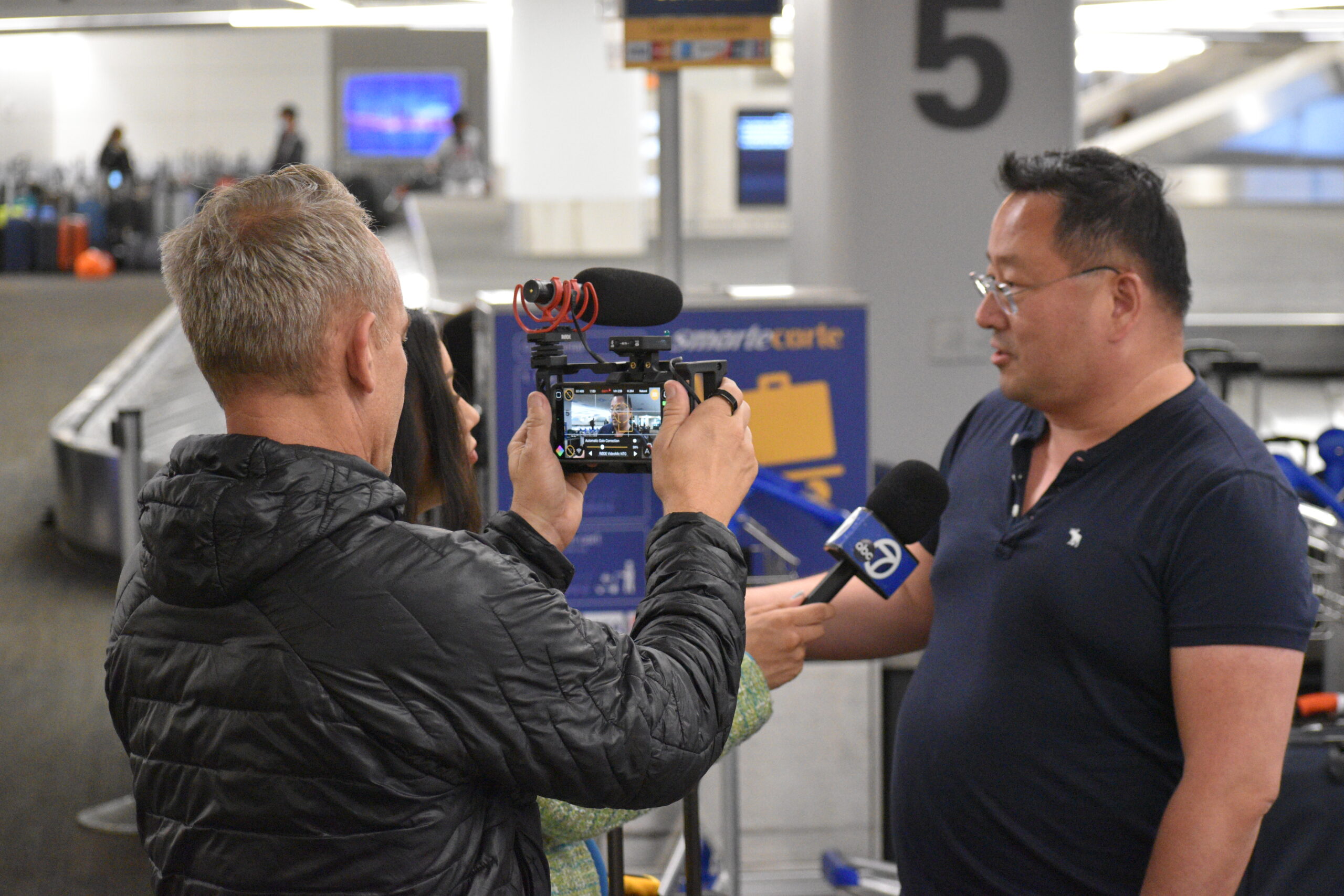 Photojournalist Stefan Stifter (left) recording an interview with a stranded United Airlines passenger with Filmic Pro v7